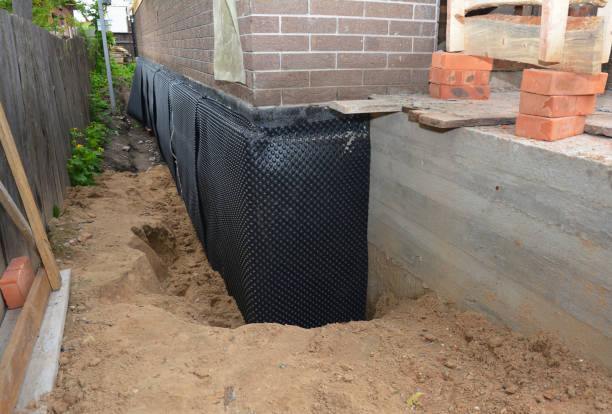 Happy homeowners after waterproofing job in Stanley